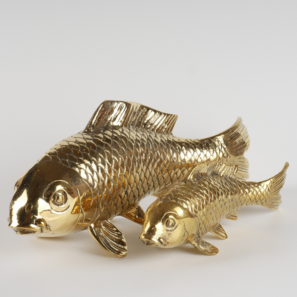 a pair of gold fish figurines sitting on top of each other