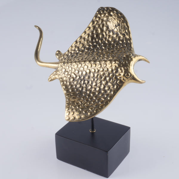 a gold sculpture of a bull's head on a black stand