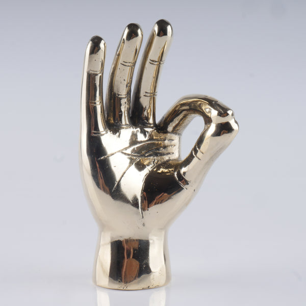 a gold colored metal sculpture of a hand