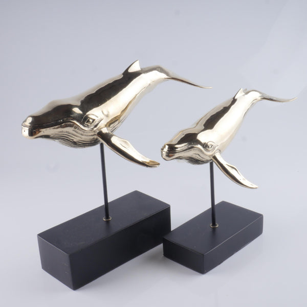 Elegant cast golden brass humpback whale sculpture with detailed features.
