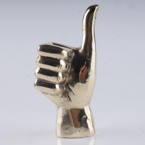a silver metal sculpture of a hand giving a thumbs up