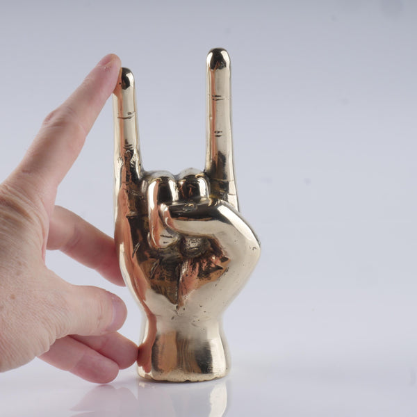 a hand that is holding up a peace sign