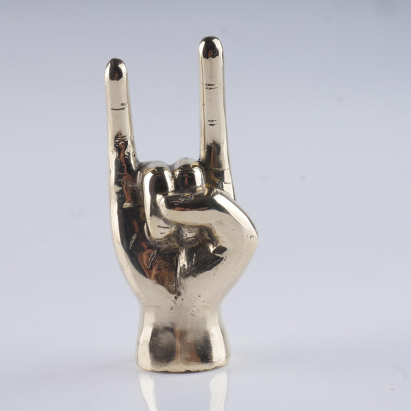 a silver statue of a hand making a peace sign