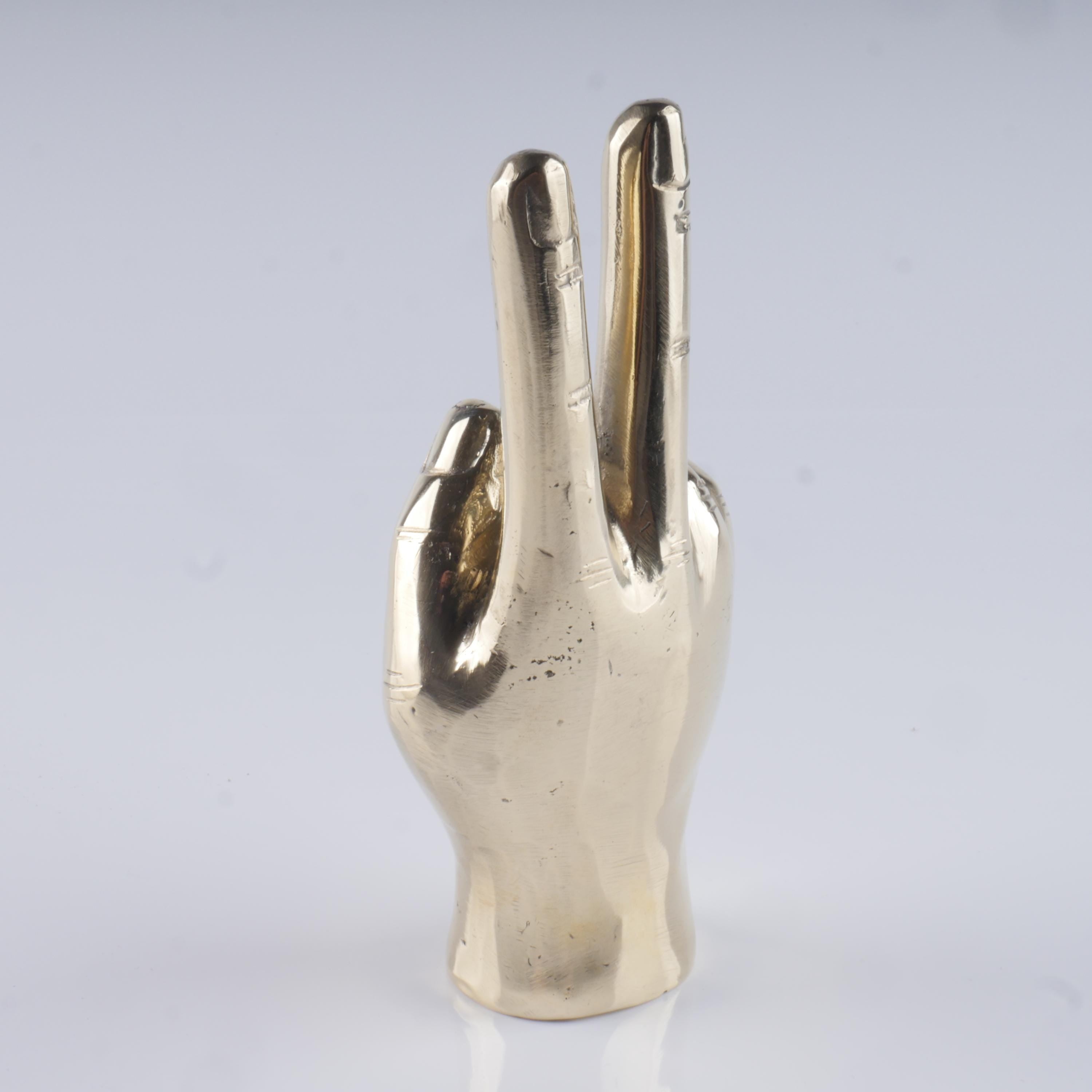 a silver metal object with two fingers in the shape of a hand
