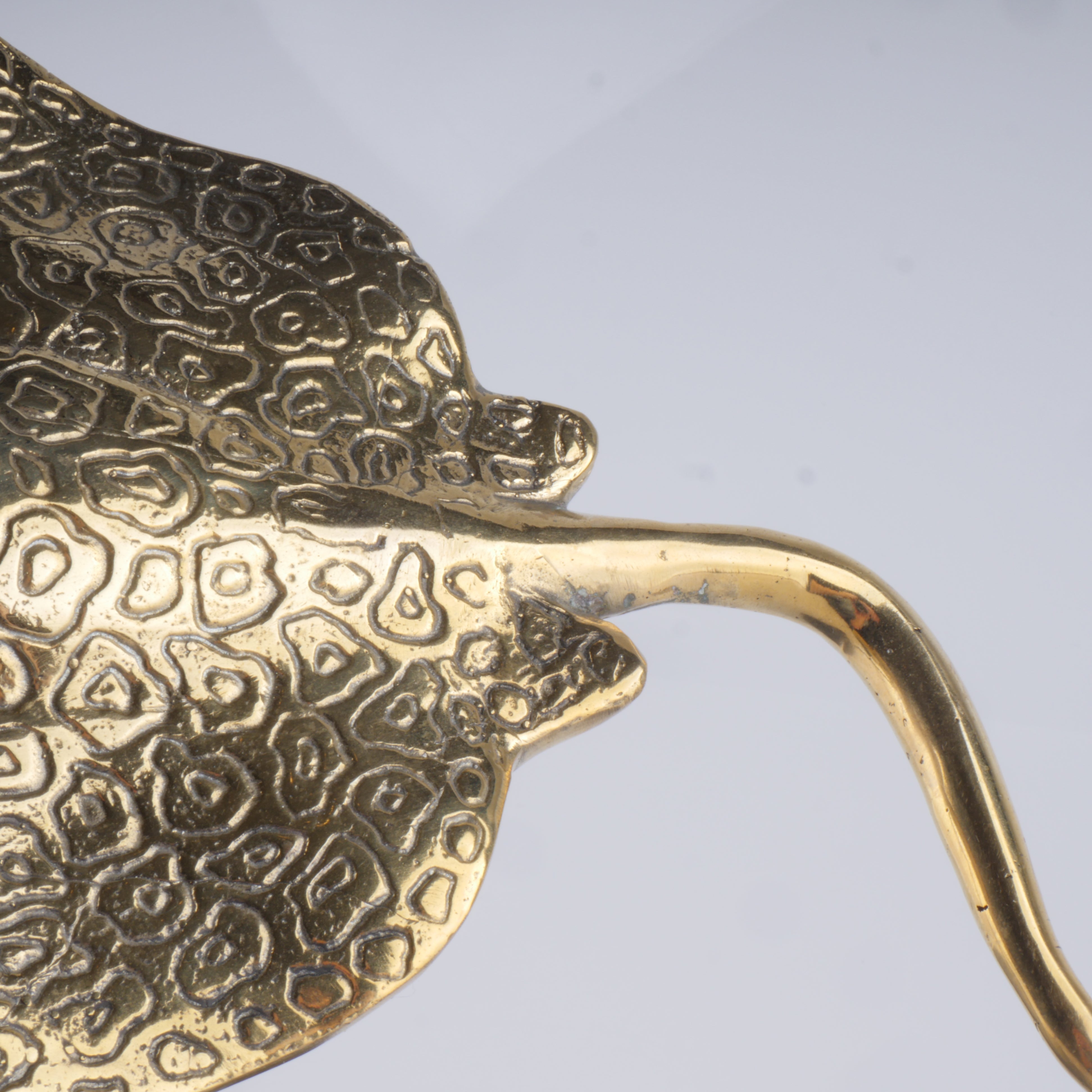 a metal object that looks like a leaf