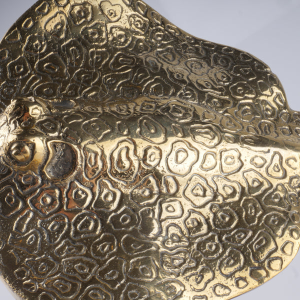 a gold plate with intricate designs on it