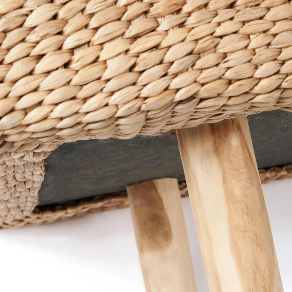 a close up of a wooden bench with a woven seat