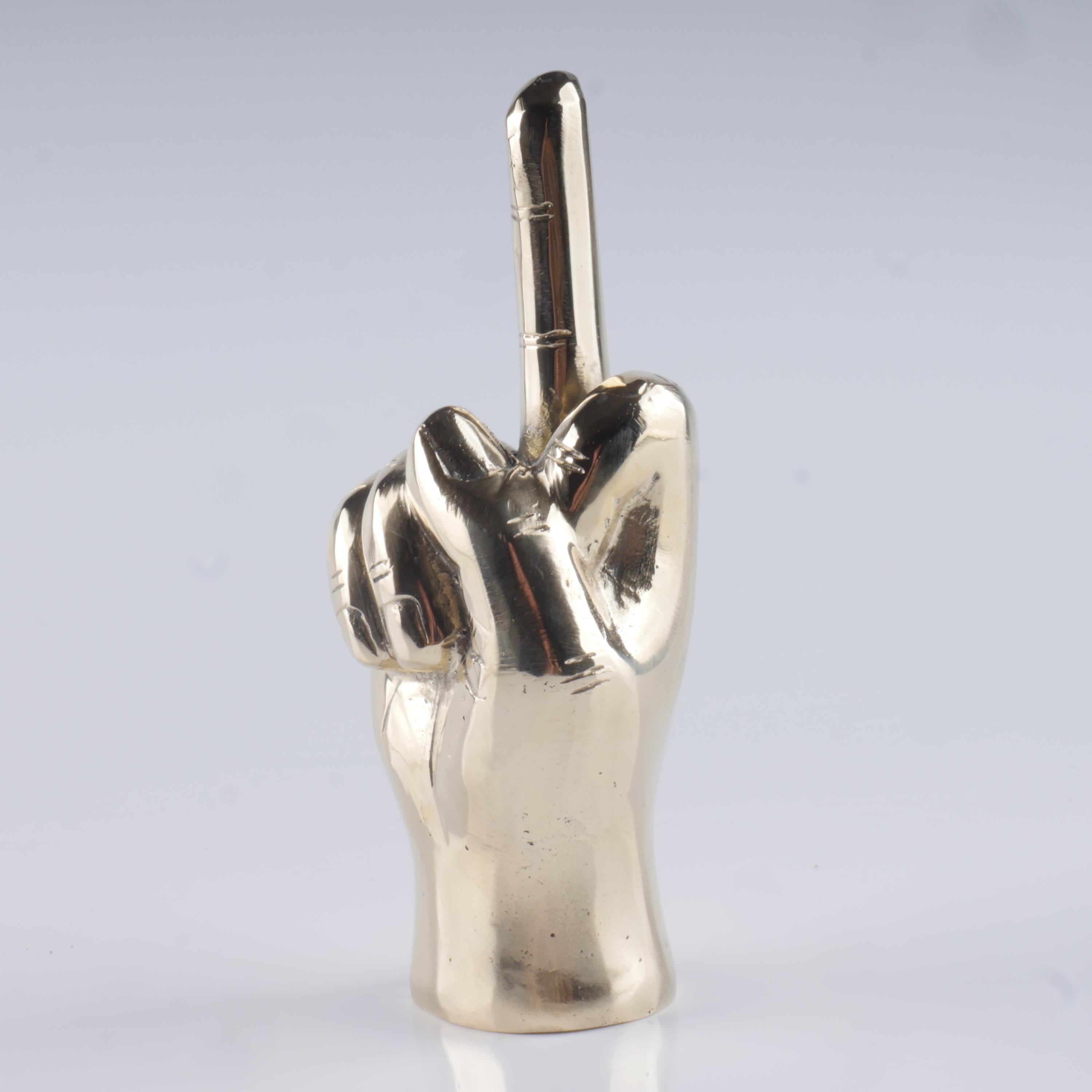 a silver statue of a hand making a peace sign